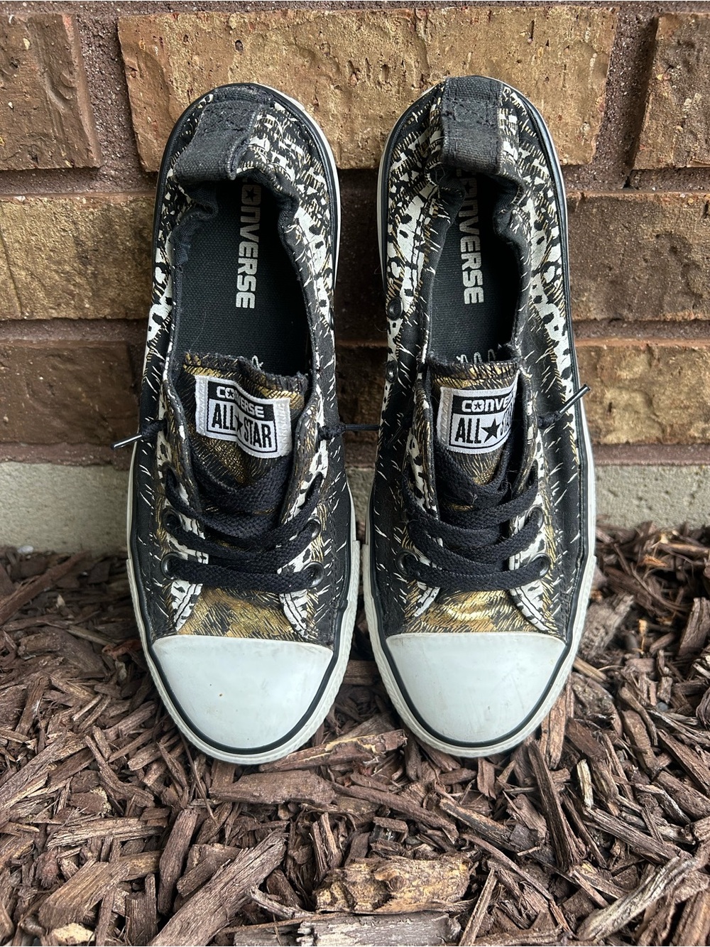 Converse Women's Low Top Sneakers in Black, White and Gold. Women’s size 8.